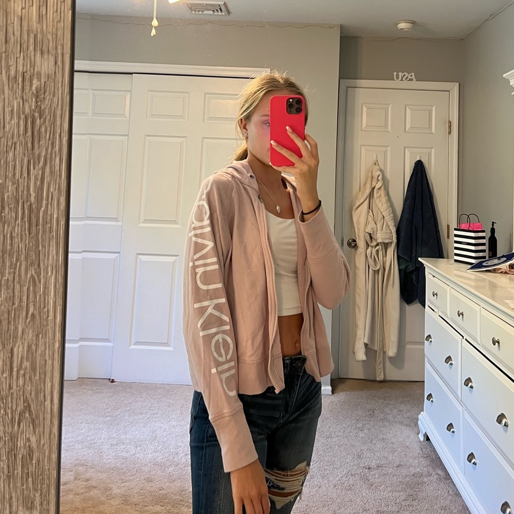 Light pink Calvin Klein zip up hoodie.